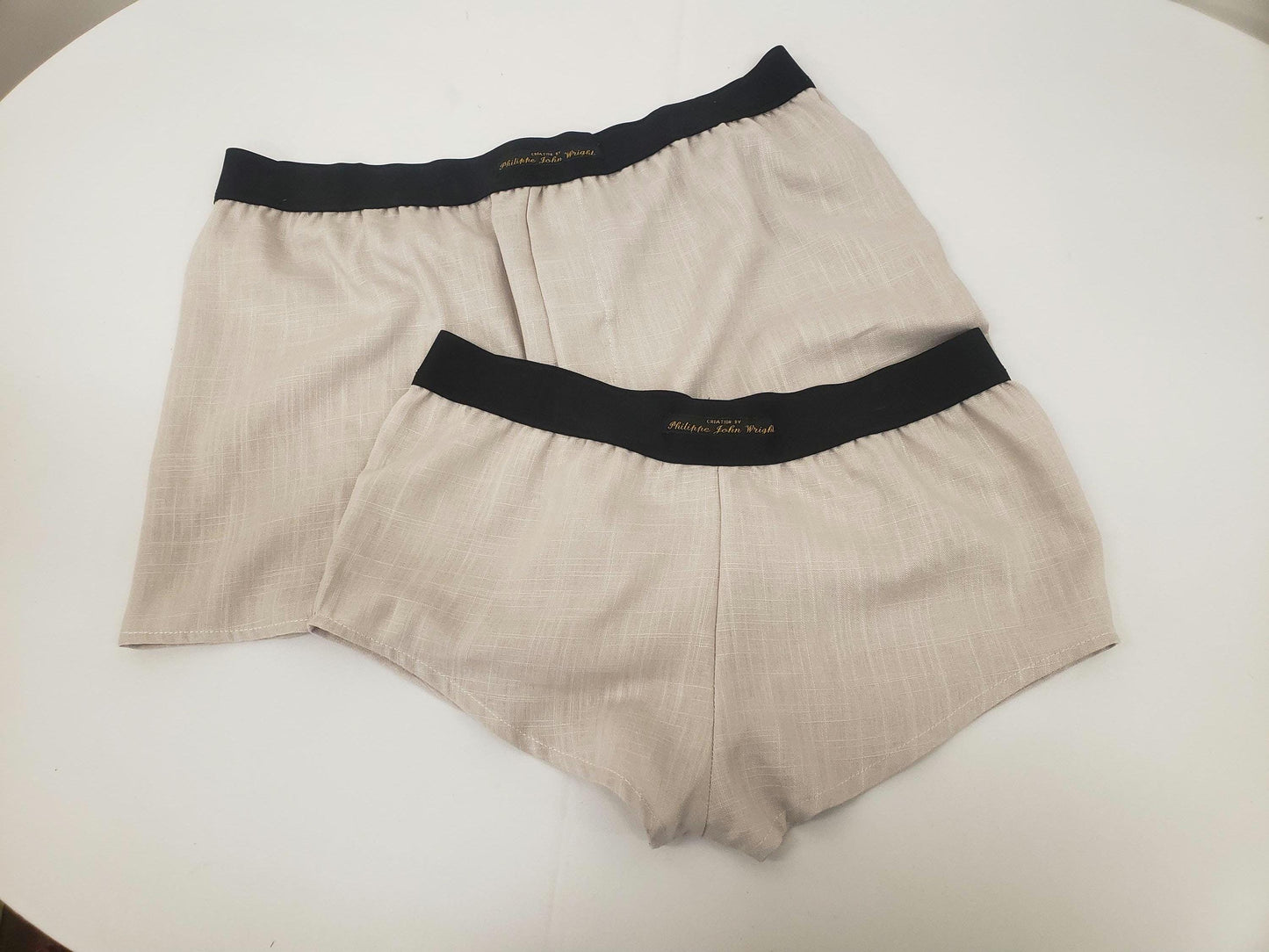 His and her BEIGE LINEN mens boxer shorts and womens linen boy shorts with black elastic.